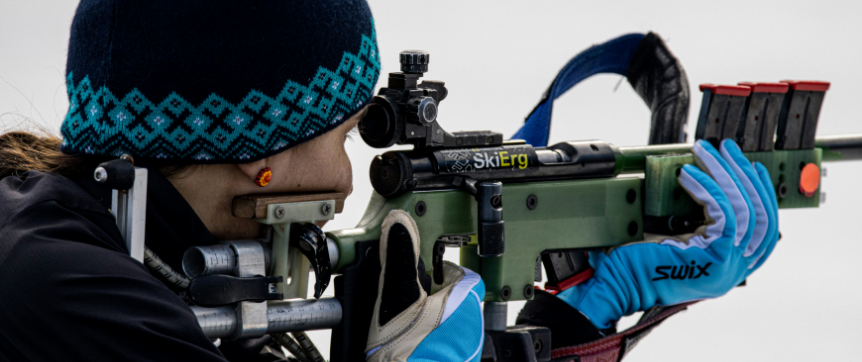 Biathlon athlete holding rifle